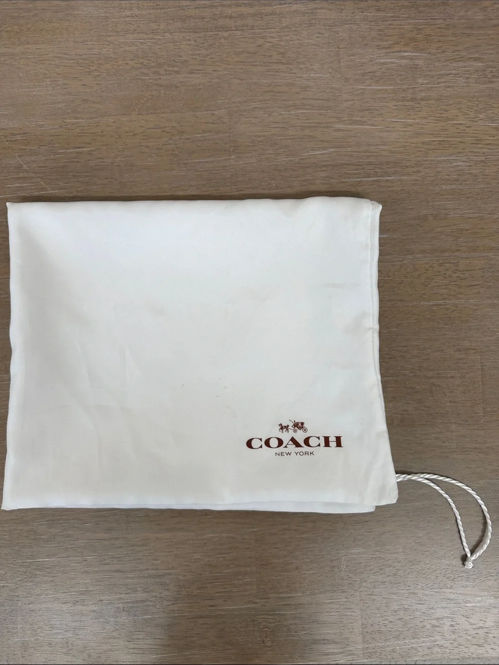 Coach 23” x 19” satin dust bag in white with brown lettering, GUC